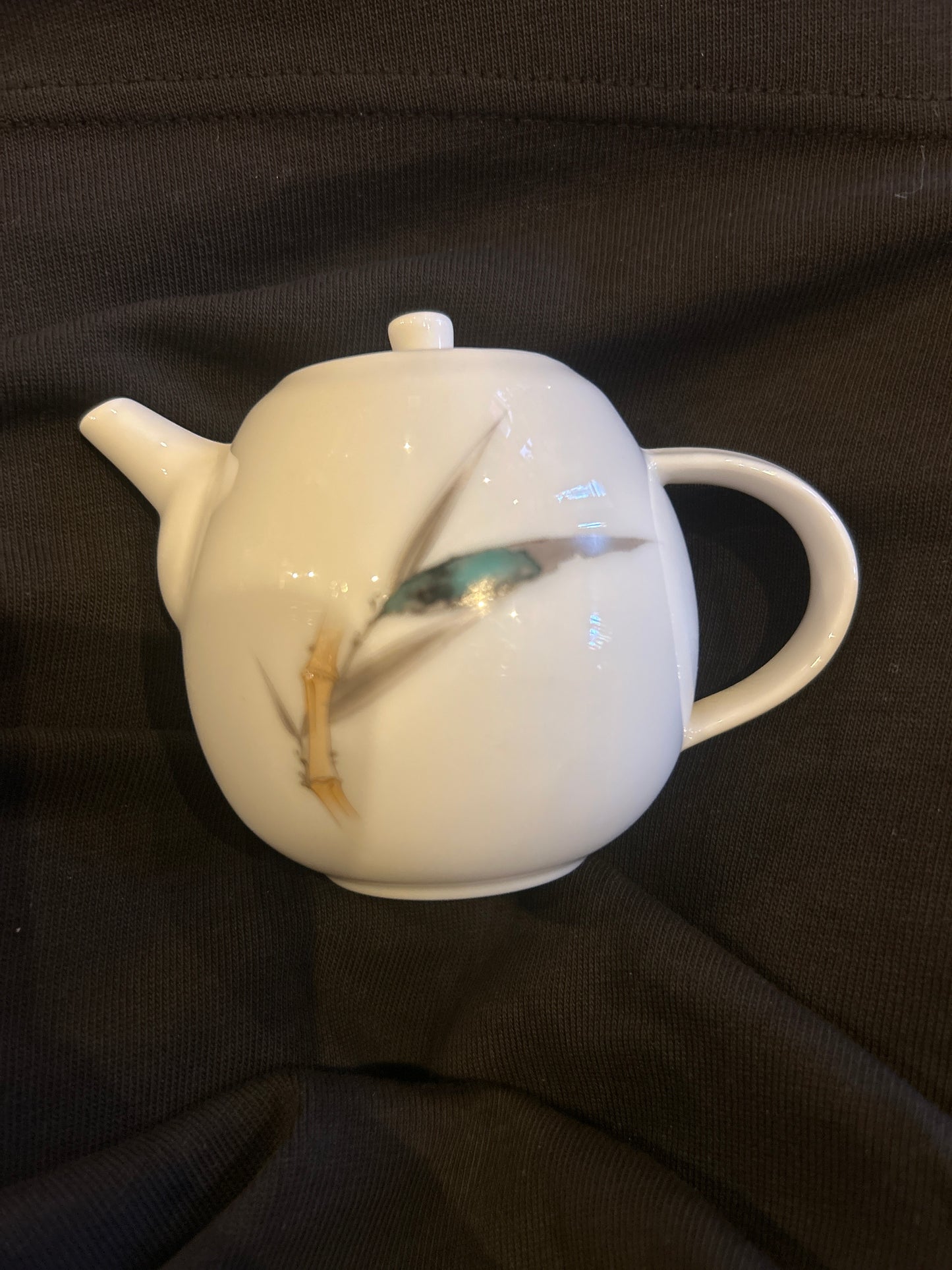 Porcelain teapot with smooth white finish and classic shape.