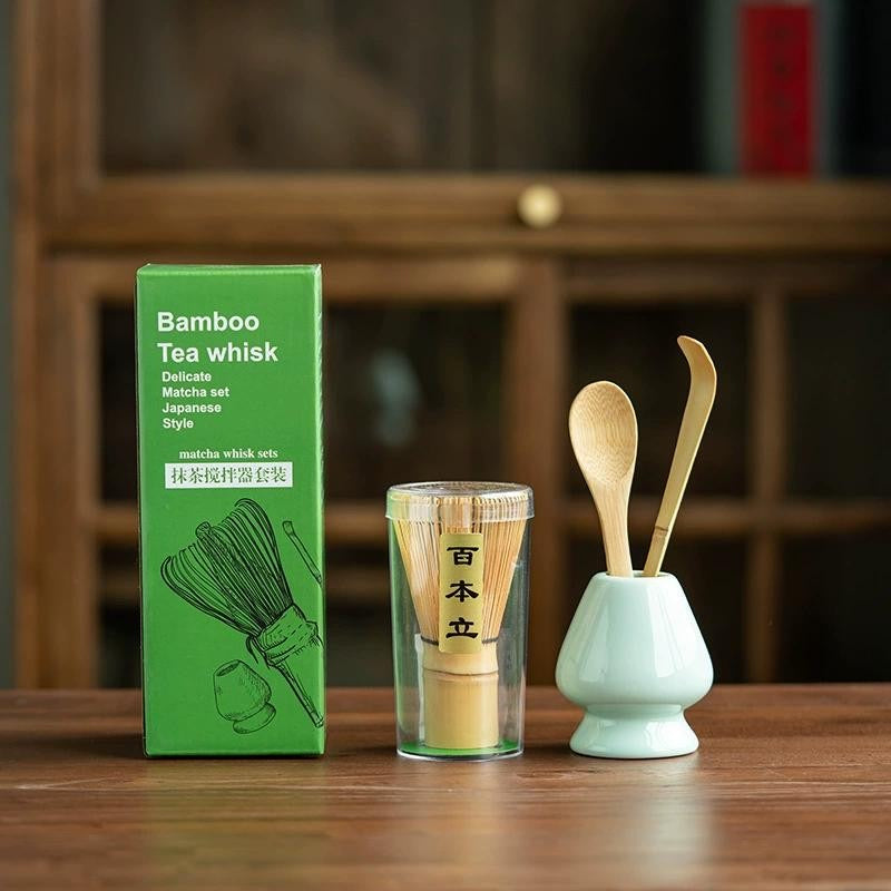Bamboo tea whisk set with green packaging on a wooden surface