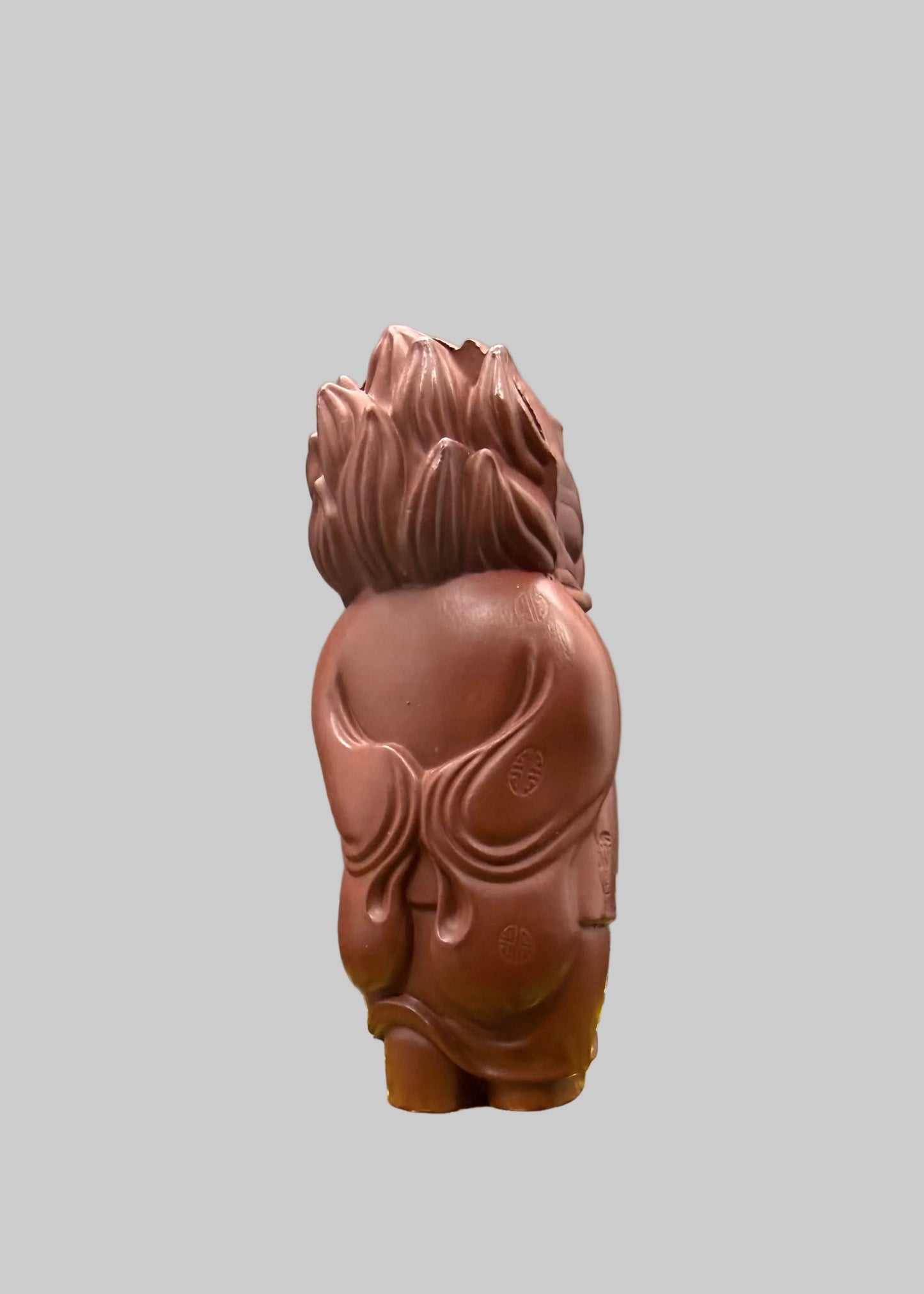 “Yixing clay lion tea figurine in traditional Chinese clothing”