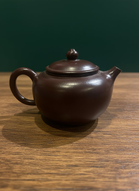 Yixing-style Deep Clay teapot, handcrafted with warm clay finish.