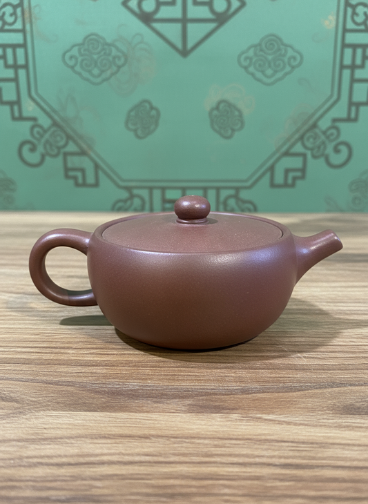 
Yixing clay teapot “Amber Lotus,” 110 ml, with lotus-inspired design in warm amber clay.
