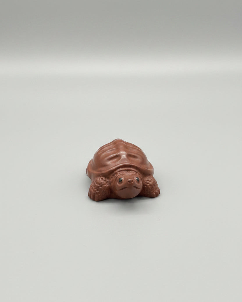 “Orange clay turtle tea figurine”