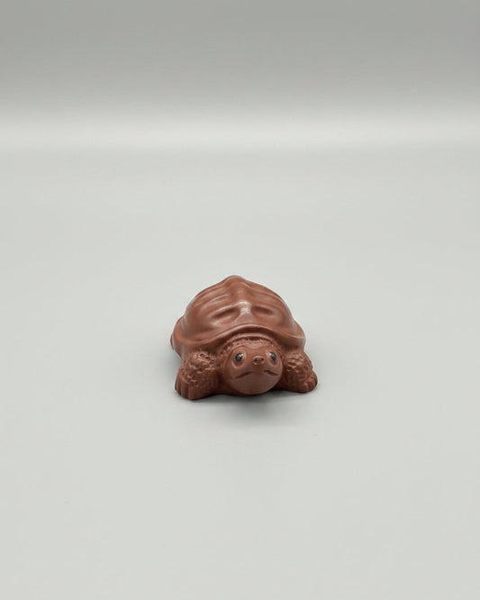 “Orange clay turtle tea figurine”