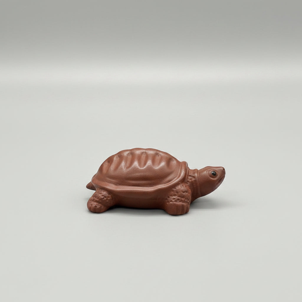 “Orange clay turtle tea figurine”