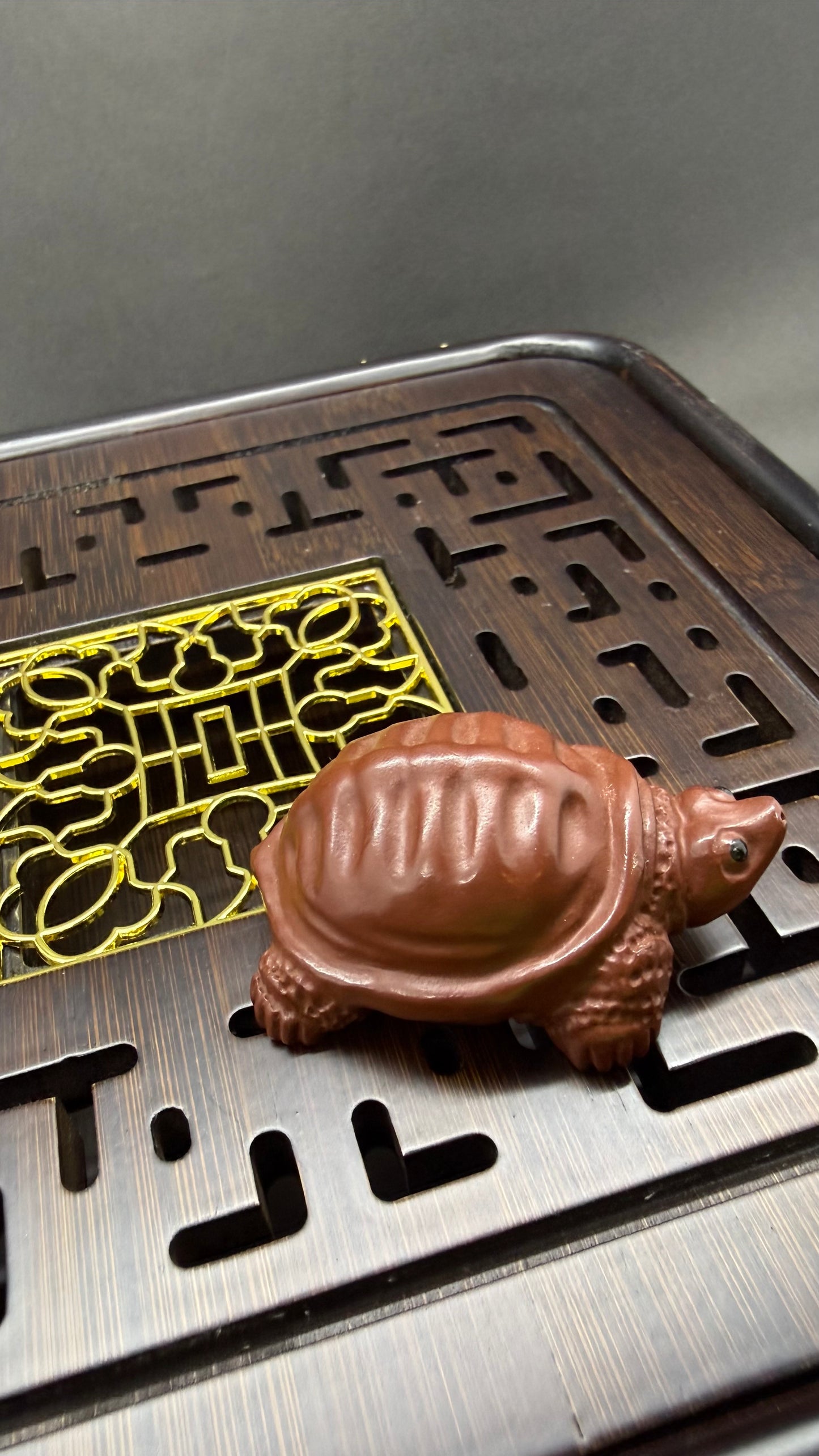 “Orange clay turtle tea figurine”