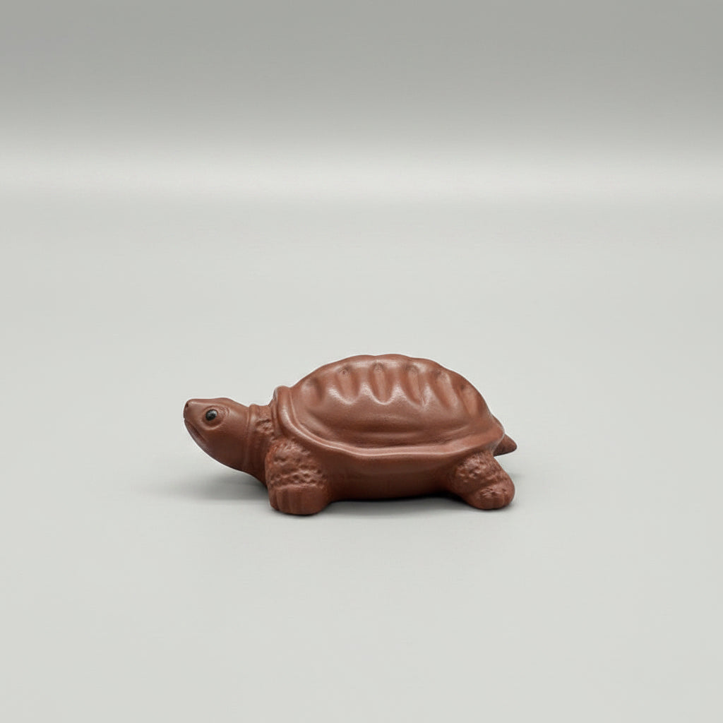 “Orange clay turtle tea figurine”