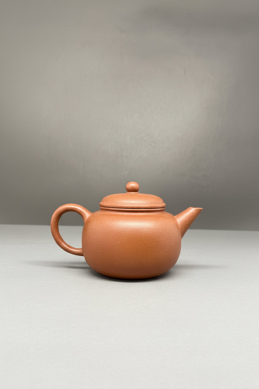 “Round orange Yixing clay teapot” 