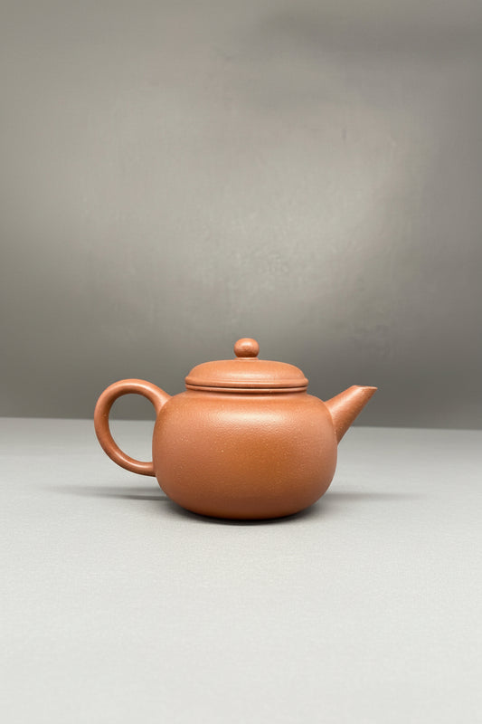 “Round orange Yixing clay teapot” 