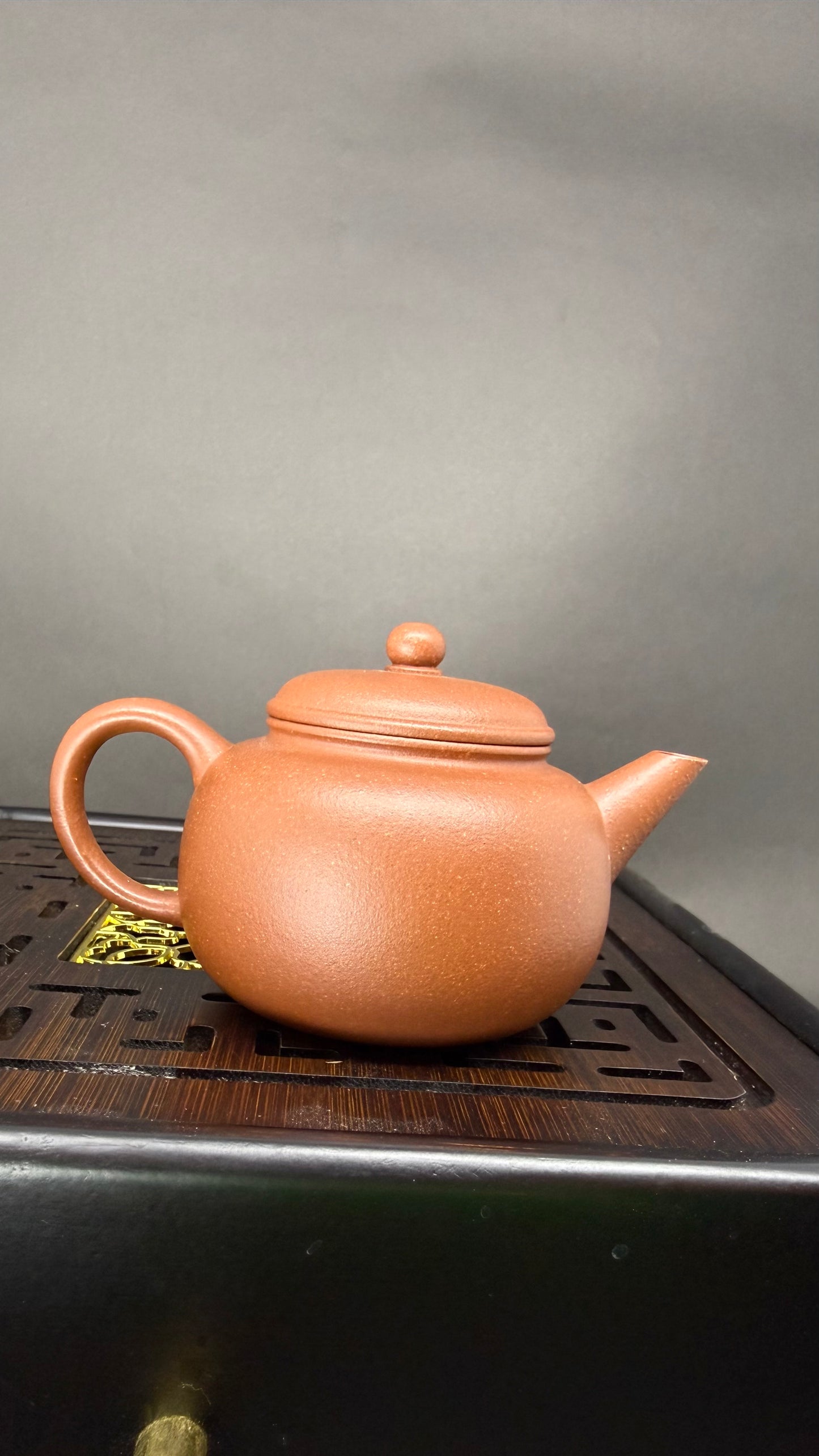 “Round orange Yixing clay teapot” 