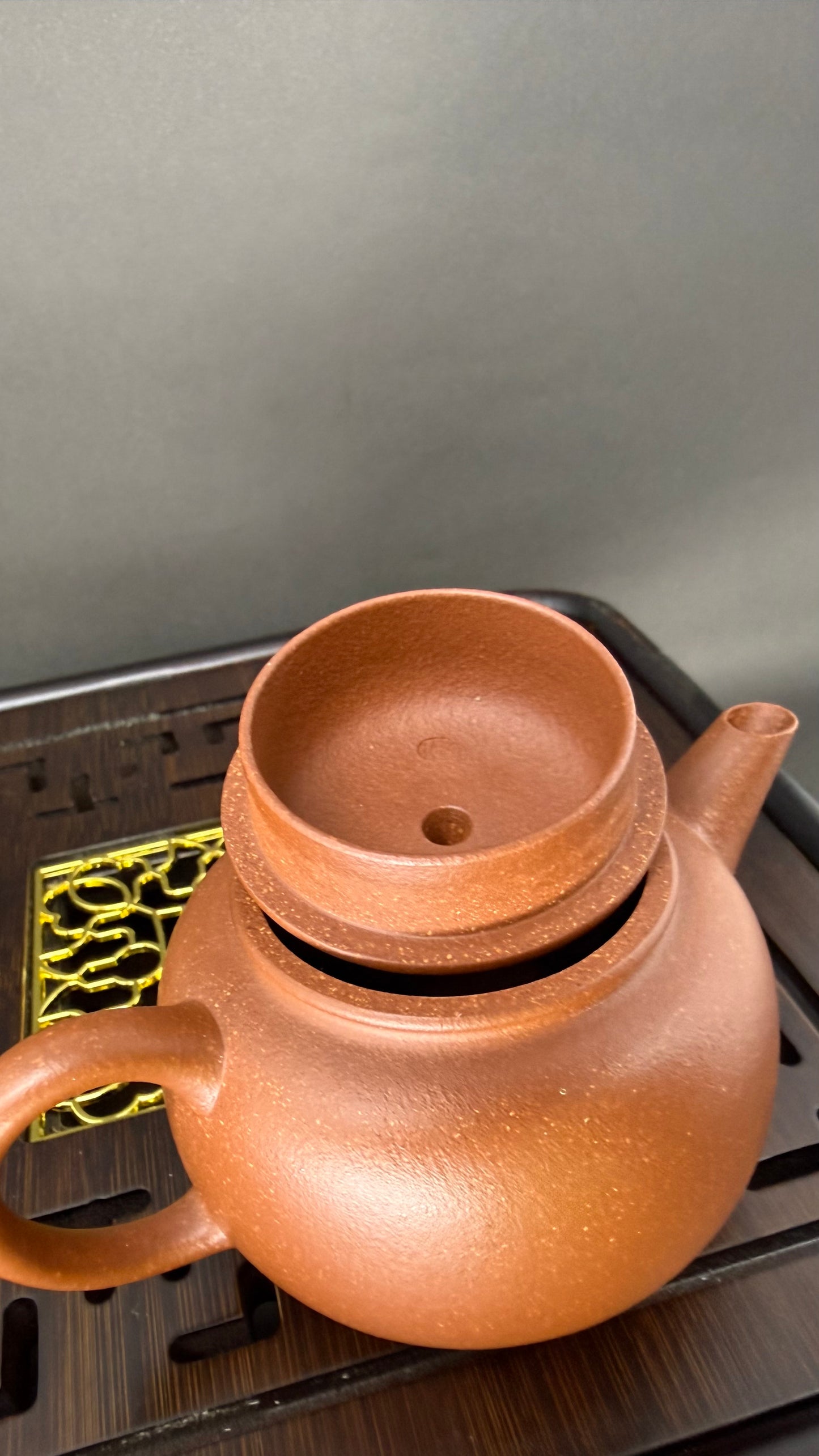 “Round Ember Yixing teapot on tea tray”