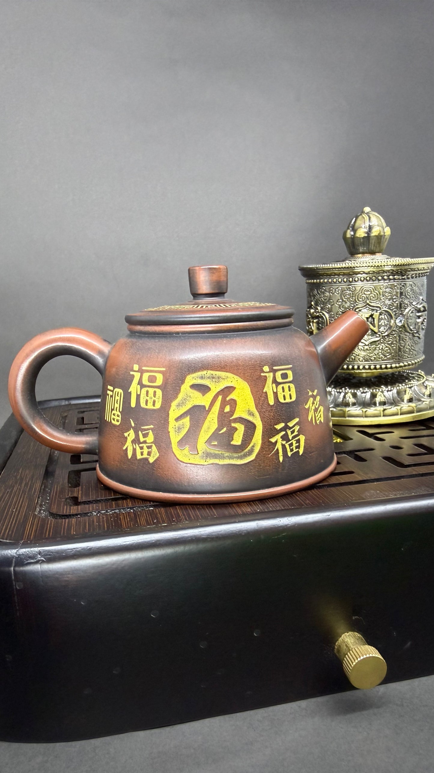“Brown-orange Yixing clay teapot with engraved characters”