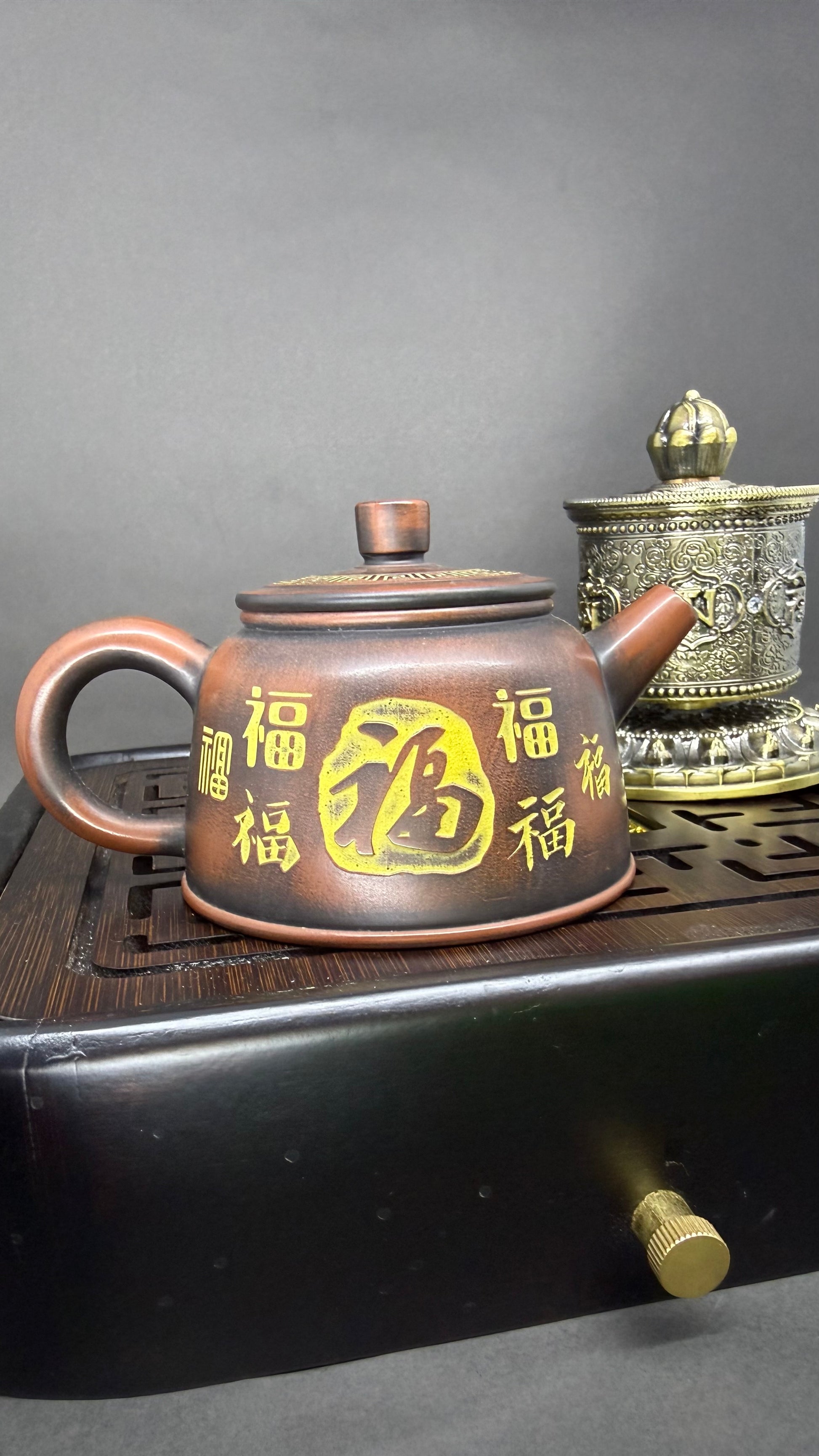 “Brown-orange Yixing clay teapot with engraved characters”