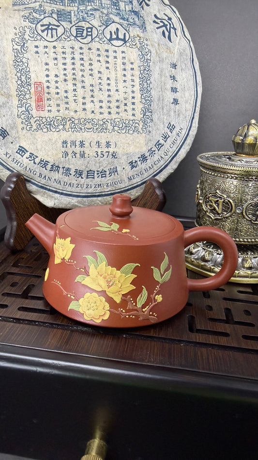 “Orange Yixing teapot with floral ornament”