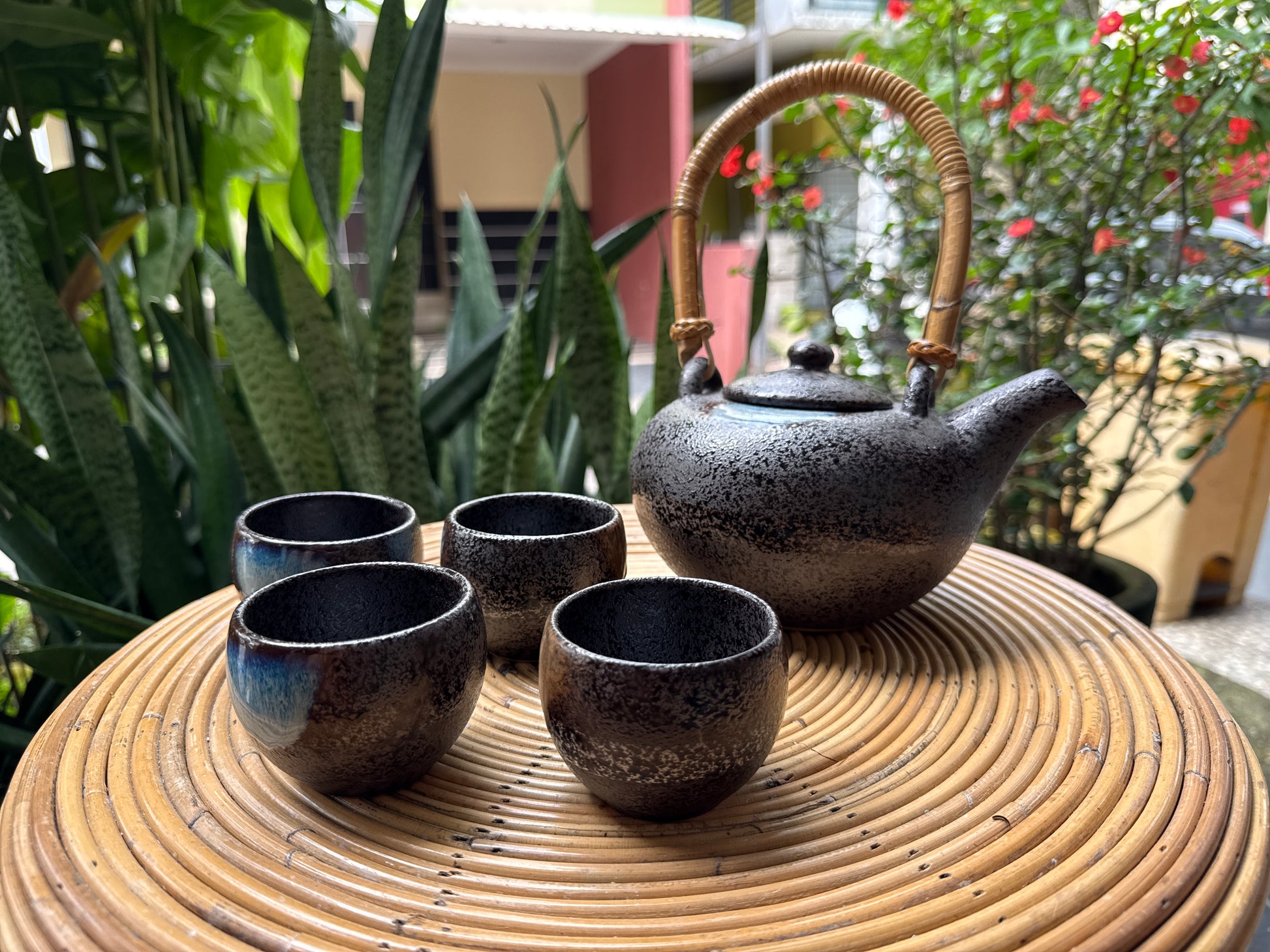 “Black ceramic tea set with teapot and four cups”