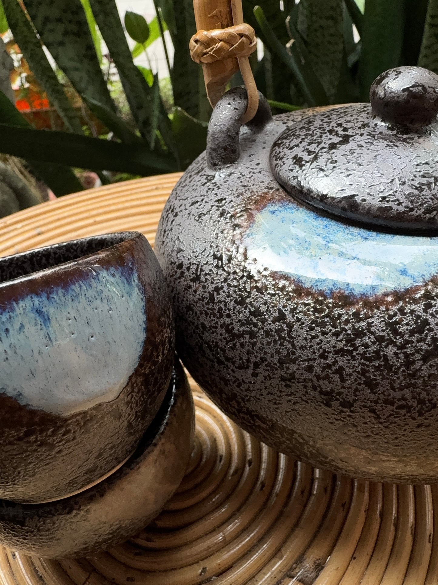 “Elegant black teapot with matching cups for tea rituals”