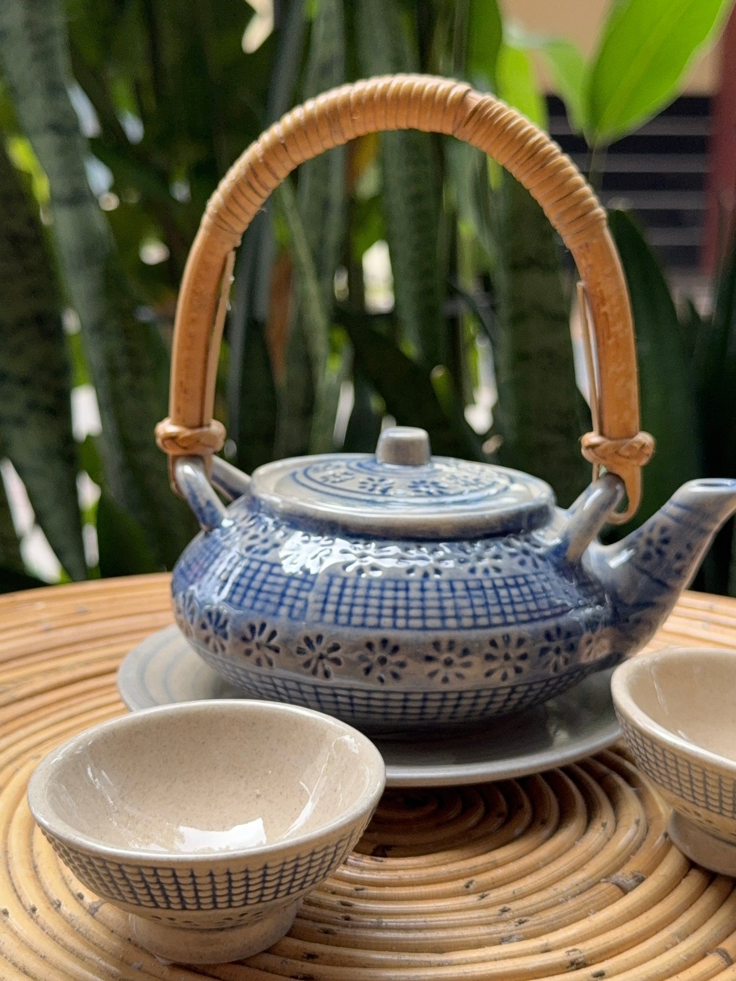 “Elegant blue teapot with matching cups for tea rituals”