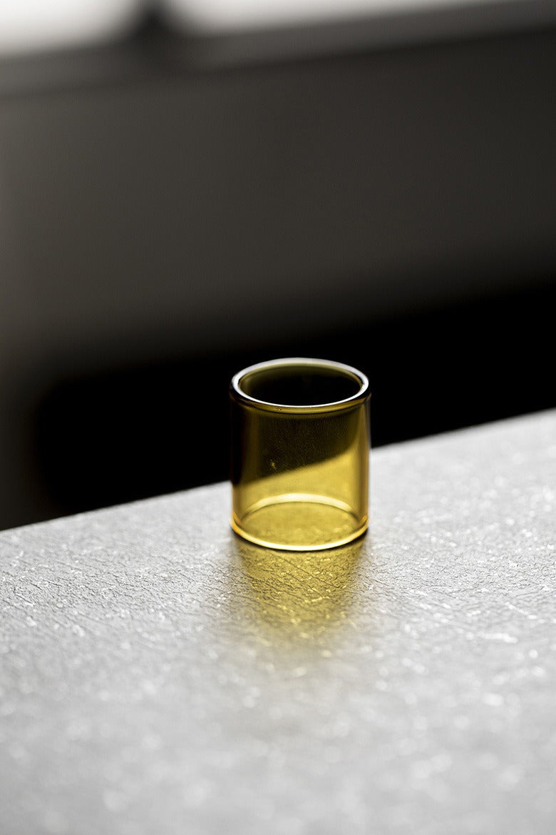 Minimalist glass holder for teapot lids on a tea table